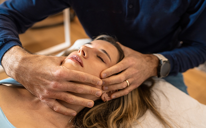 Osteopath performing cranial therapy